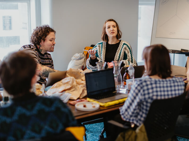 Colleagues enjoying a virtual team building activity in office space