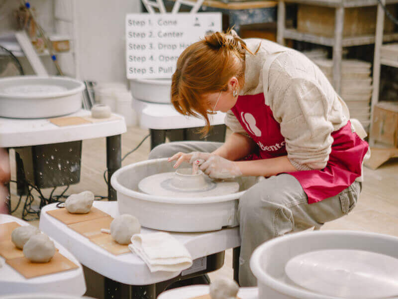 woman at a pottery wheel throwing class