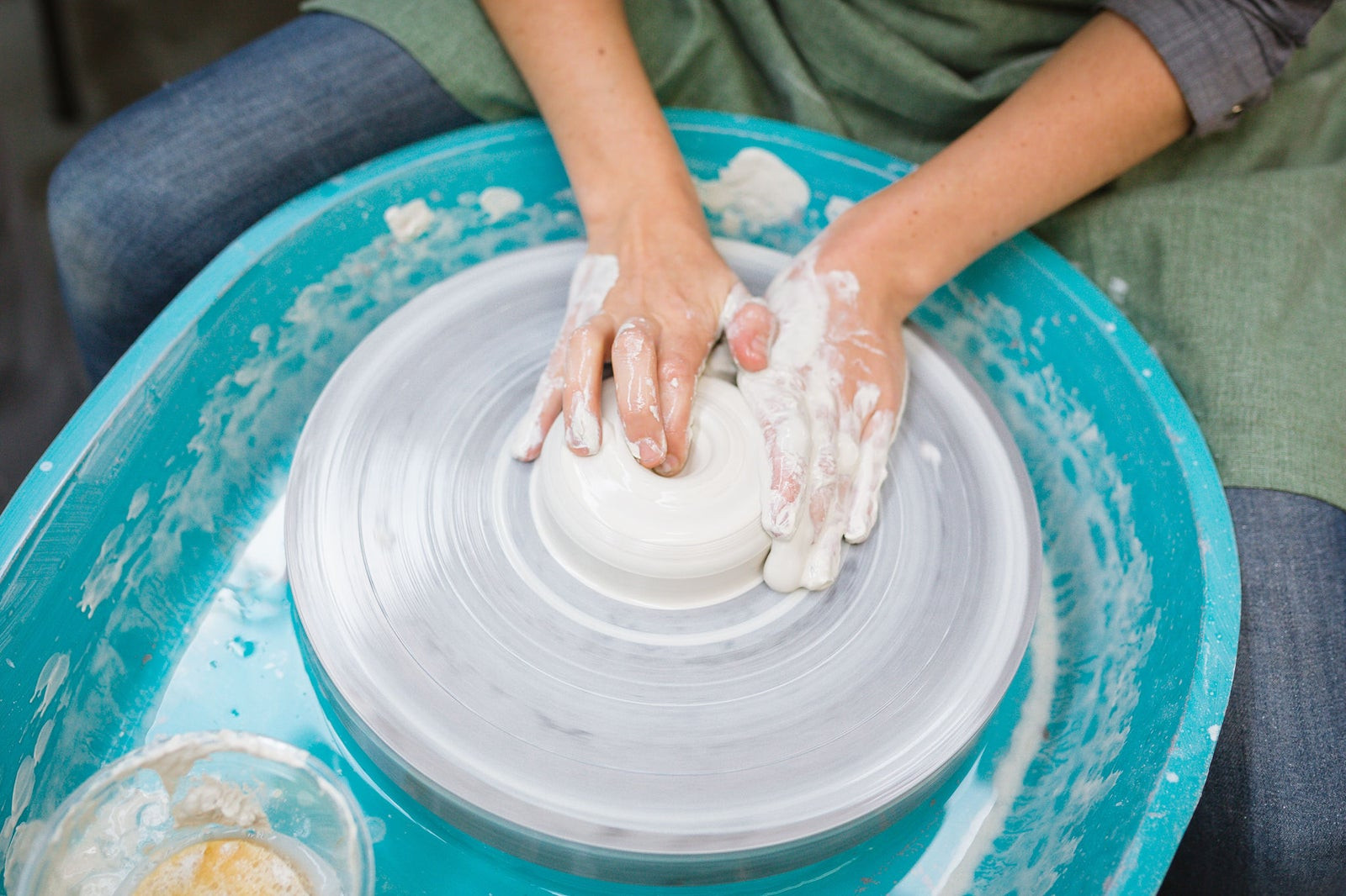 A persons hands wheel throwing