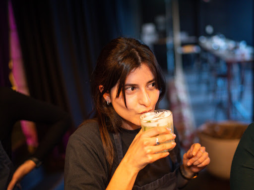 A woman drinks a handmade cocktail in Melbourne