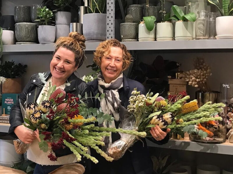 Two friends with their wildflower bouquets