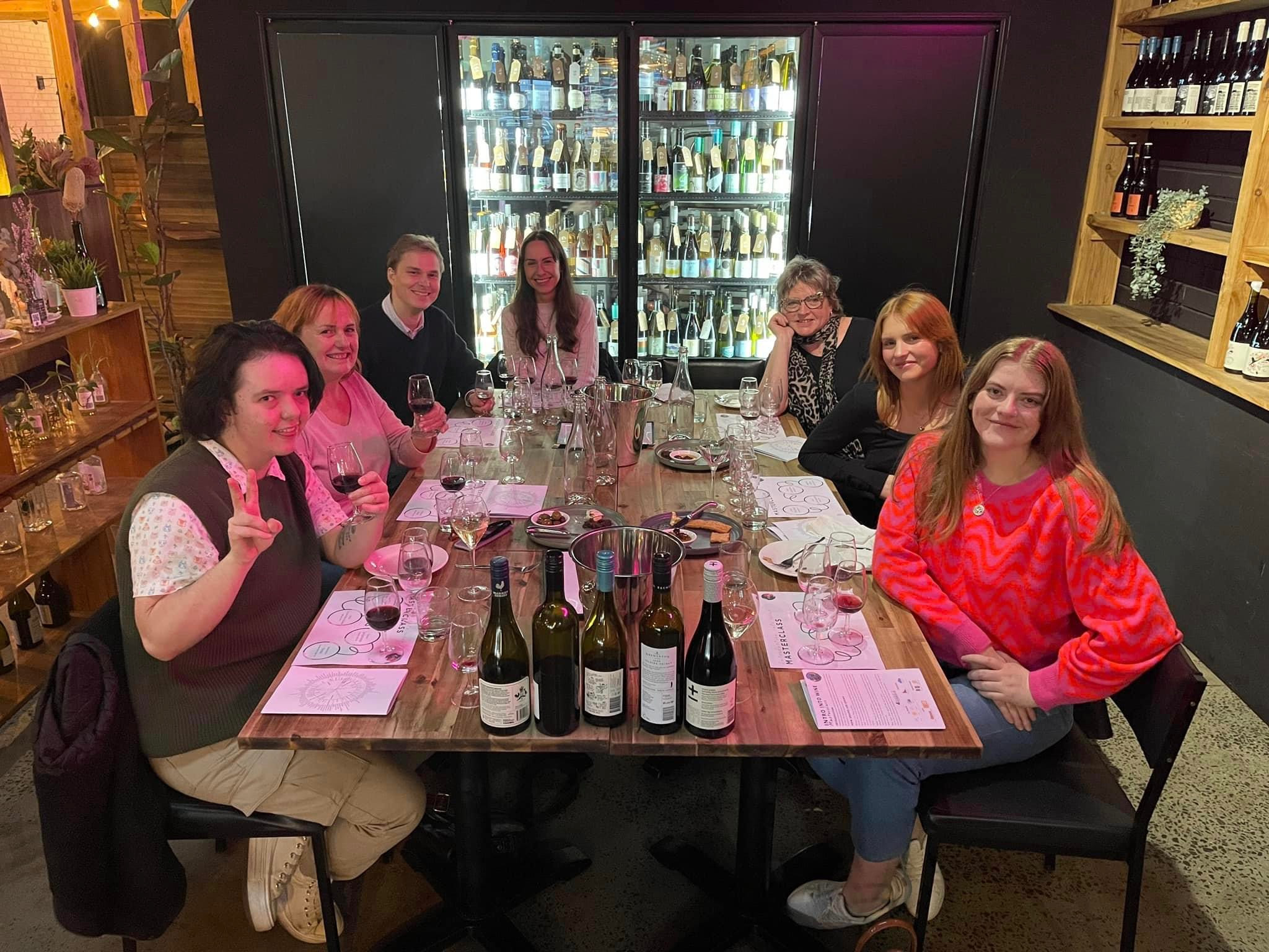 People smiling at a wine tasting experience