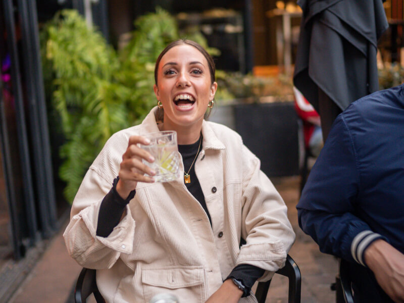 A woman holding up cocktail