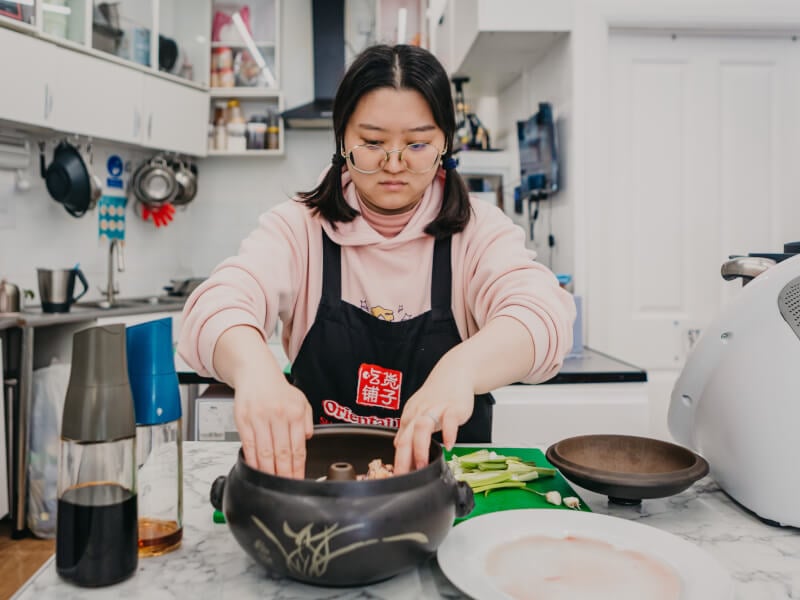 Woman making hotpot at Asian cooking class for Mother's Day