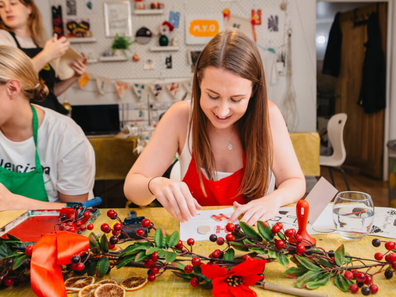 A woman enjoys making her own Christmas cards