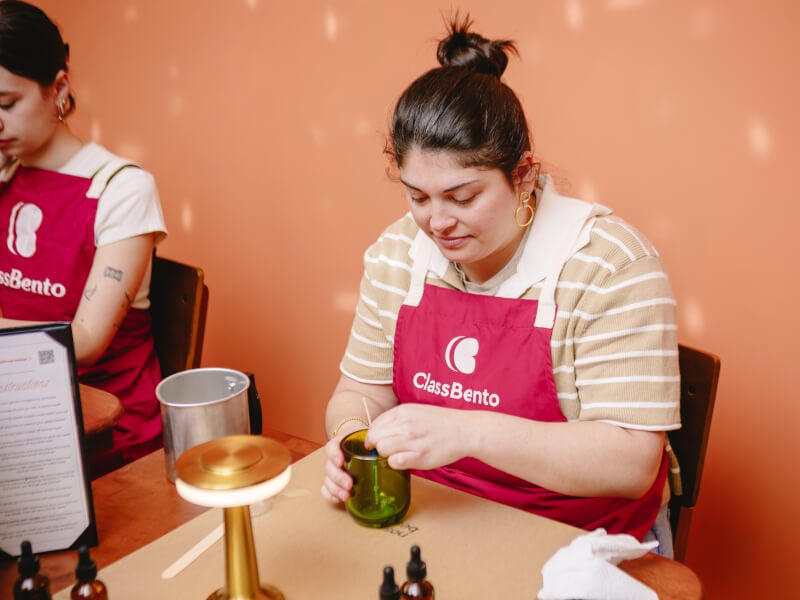 A woman unwinds at a candle making class she got as an experience gift