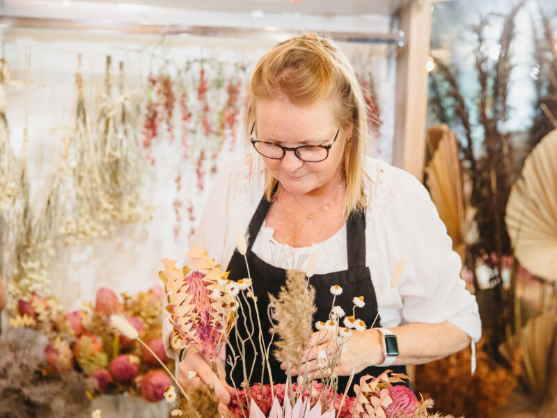 A mum selects flowers for her bouquet at a flower arranging class
