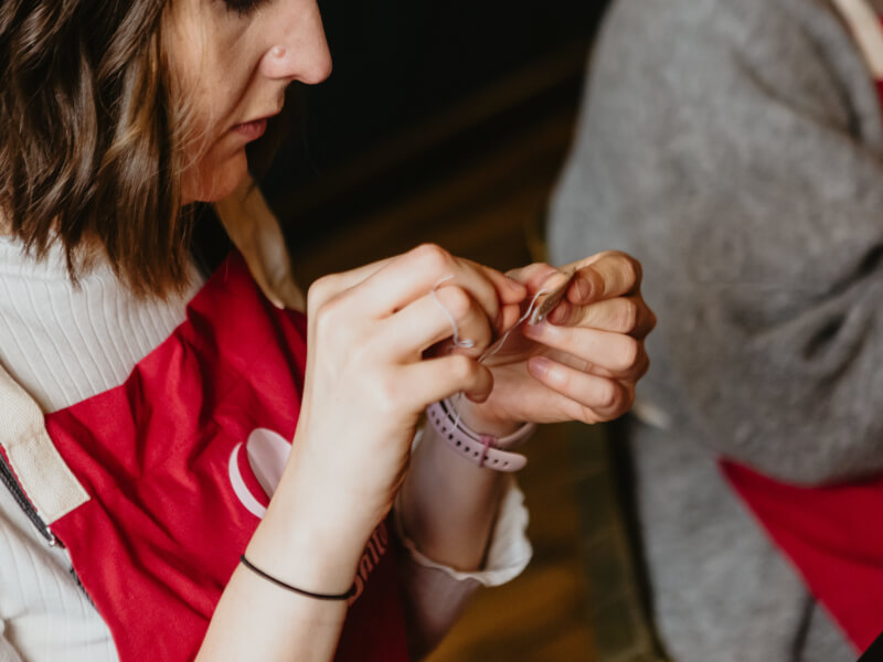 Close up of woman sewing in a class