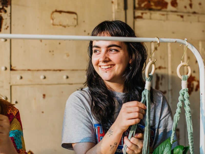 woman smiling at macrame class