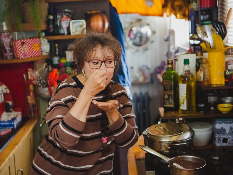 A woman tasting her cooking at a cooking class for Mothers Day