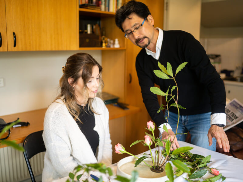 A mother admiring her ikebana arrangement