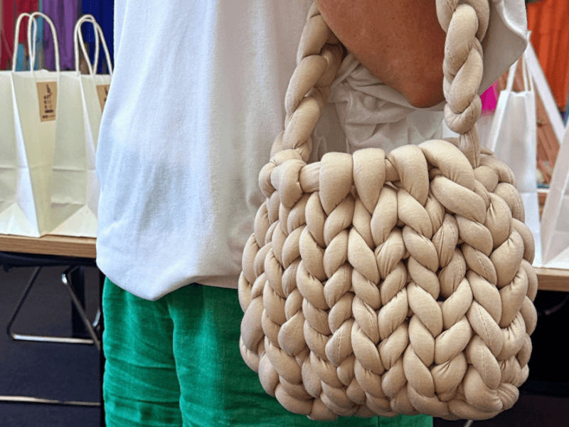 woman holding hand knitting bag