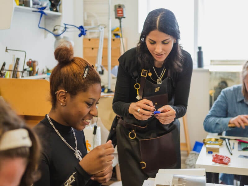 Two women enjoying a jewellery making class
