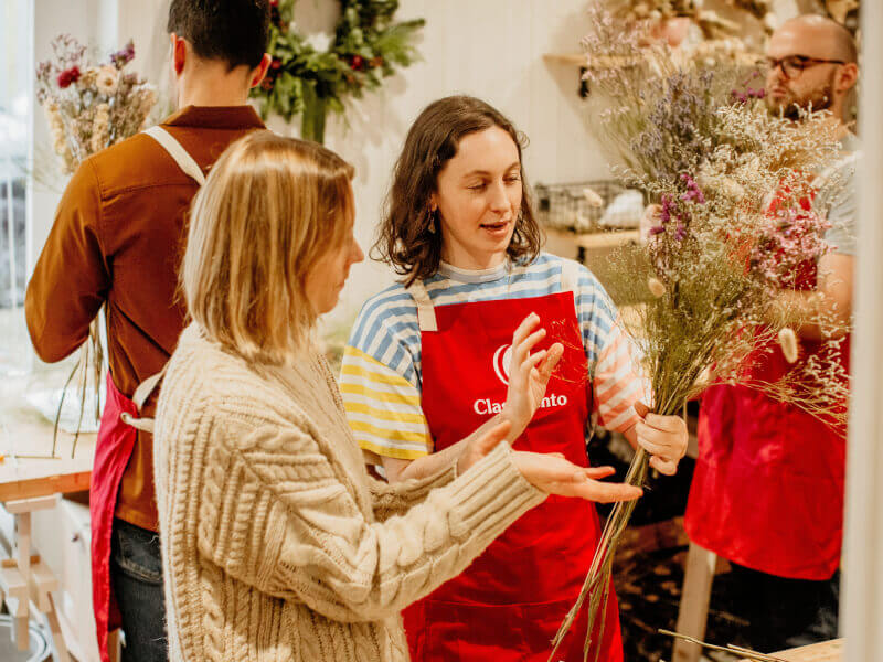 A woman arranges flowers