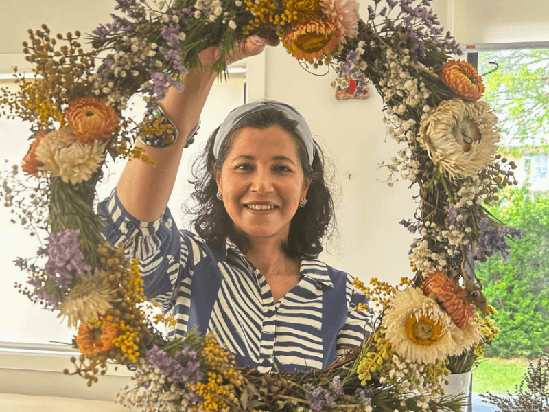 wreath making christmas party idea woman holding wreath
