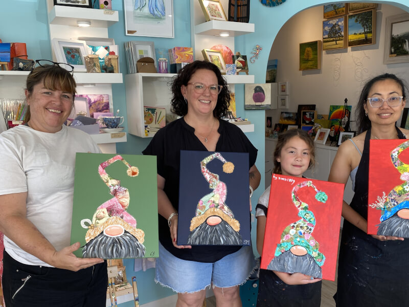 A fun group show off their festive paintings
