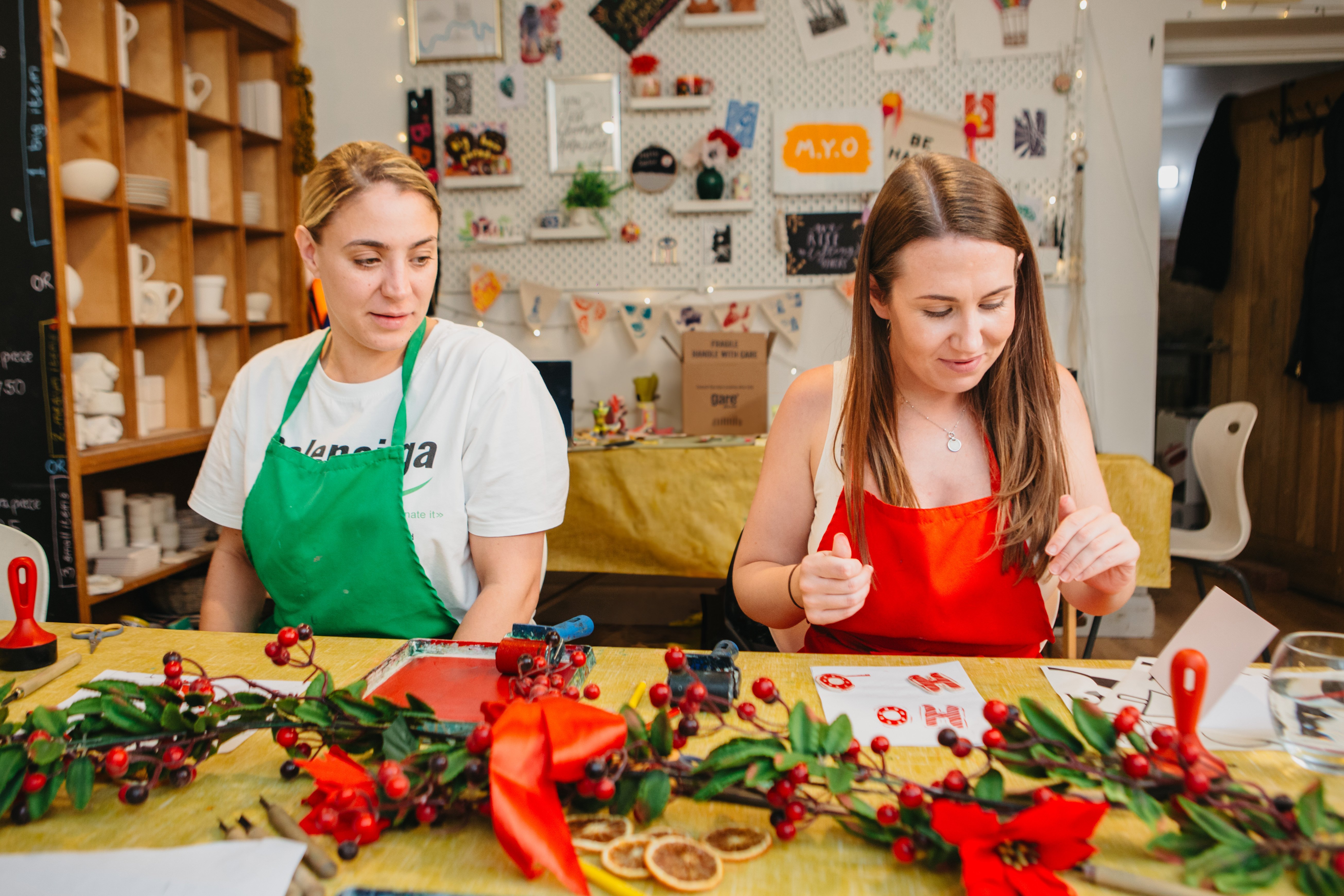 Two friends enjoying a Christmas card making workshop