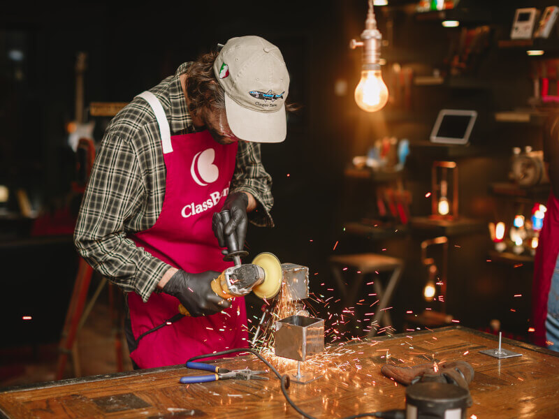 A young man enjoys a metalwork class